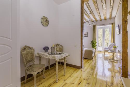 a dining room with a table and chairs in a room at Oriente Palace Apartments in Madrid