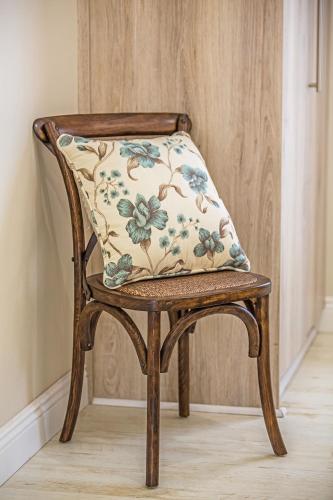 a chair with a pillow on the back of it at AnnVilla Guesthouse in Klerksdorp