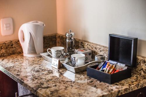 a kitchen counter with a counter top with items on it at AnnVilla Guesthouse in Klerksdorp