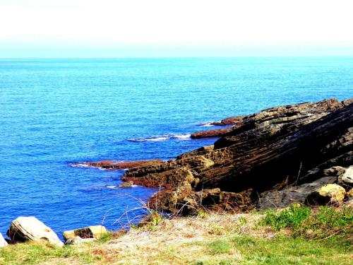 a view of the ocean from a cliff at Casa Rural Postigu in Hondarribia