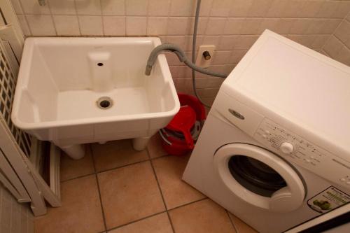 a bathroom with a washing machine and a sink at Bed & Breakfast Porta Santi in Cesena