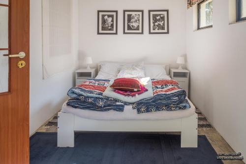 ein Bett mit Decken und Kissen darauf in einem Zimmer in der Unterkunft Domek letniskowy Sieraków in Sieraków