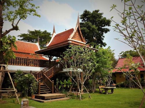 a house with a staircase and a roof at Baan Thai House in Phra Nakhon Si Ayutthaya
