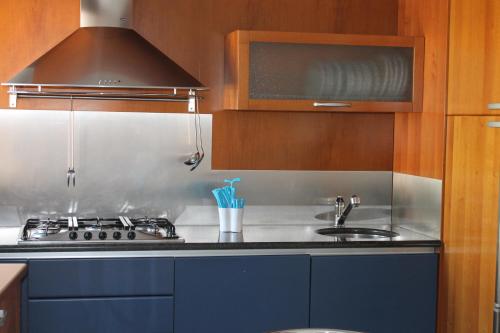 a kitchen with a stove and a sink at Suite Mavino Appartamenti in Sirmione