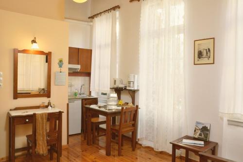 a kitchen with a table and a kitchen with a sink and a kitchen at Silde Studios & Apartments in Chania
