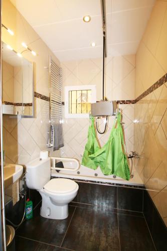 a bathroom with a toilet and a sink and a mirror at Villa Sonnenschein in Els Poblets
