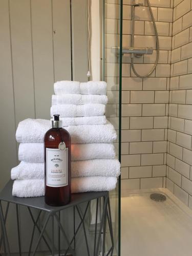 a pile of towels on a table in a bathroom at The Stable, Yew Tree Farm Holidays, Tattenhall, Chester in Chester