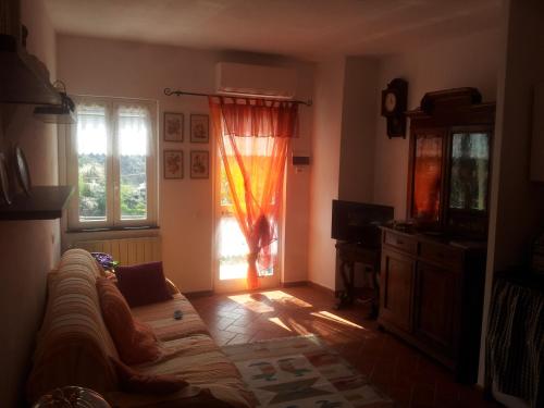 a living room with a couch and a window at Casa Violetta in Levanto