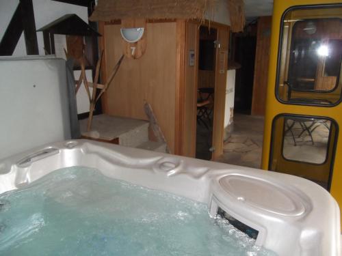 a bath tub filled with water in a room at Schwarzwald-Gasthof Hirsch in Bad Wildbad