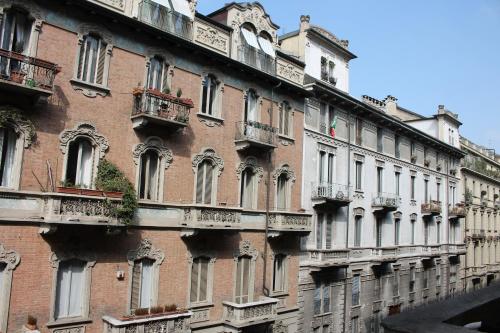 a large brick building with windows and balconies at La Luna e i Faló Luxury Accomodation in Turin