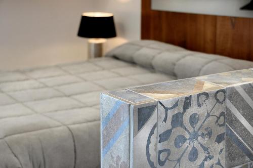 a bed in a room with a table with a couch at Villa Battista in Ercolano