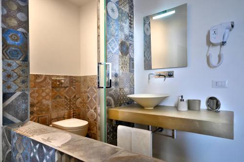 a bathroom with a sink and a toilet at Villa Battista in Ercolano