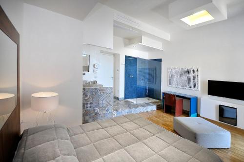 a bedroom with a large bed and a fireplace at Villa Battista in Ercolano