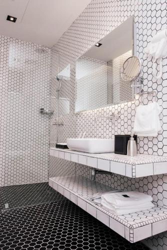 a white bathroom with a sink and a mirror at M Boutique Kampar in Kampar