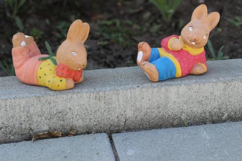 three figurines of rabbits sitting on a concrete ledge at Amso Residence in Sibiu