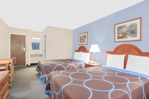 a hotel room with two beds and a bathroom at Super 8 by Wyndham Middletown in Middletown
