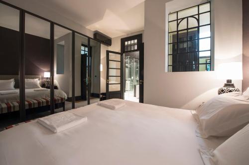 A bed or beds in a room at Deco Gem Aliados