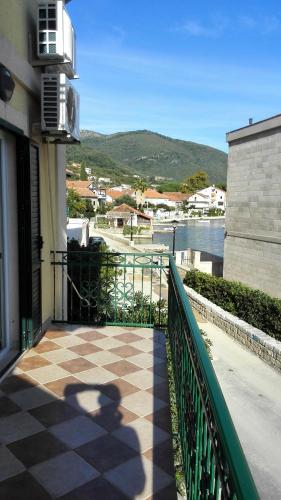 a balcony of a building with a checkered floor at Holiday Home Ploski in Herceg-Novi