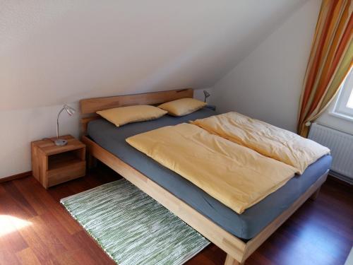 a bedroom with a bed with a wooden bed frame at Ferienwohnung Am Schwanensee in Plön