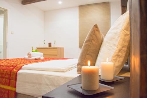 a bedroom with two candles on a bed at Apartments Bego Spa & Wellness in Crikvenica