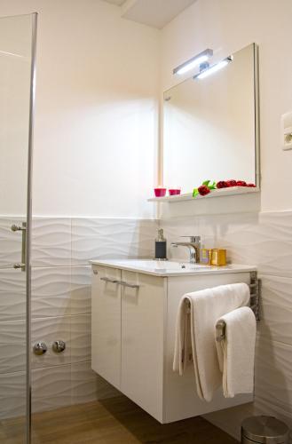 a bathroom with a sink and a mirror at Apartments Bego Spa & Wellness in Crikvenica