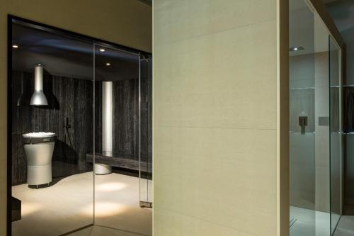 a bathroom with a glass shower and a toilet at Almar Jesolo Resort & Spa in Lido di Jesolo