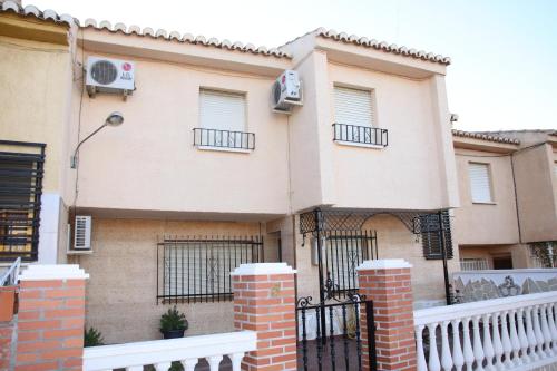 a large house with a fence in front of it at Casas los Rosales in Guadix