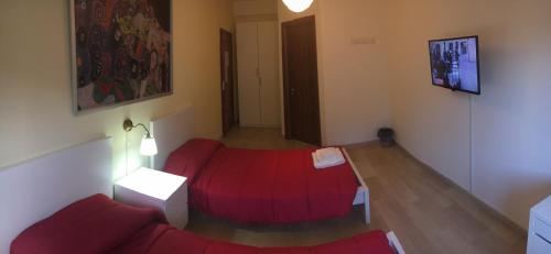 a living room with a red couch and a table at B&B Pontepiccolo in Catanzaro