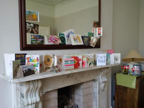 a fireplace with books on it with a mirror at Exceptional guest rated 1 bedroom Kensington apartment with Super Wifi in London