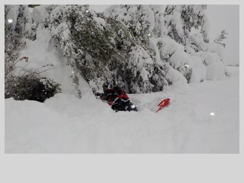 a person is laying in the snow at B&b Gennargentu in Fonni