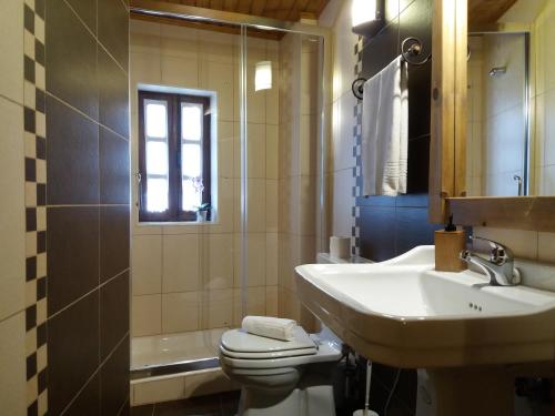 a bathroom with a sink and a toilet and a tub at Casinha do México in Gondramaz