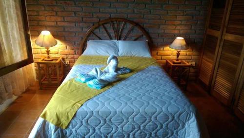 a bedroom with a bed with a towel on it at Hosteria Cumilinche in Same