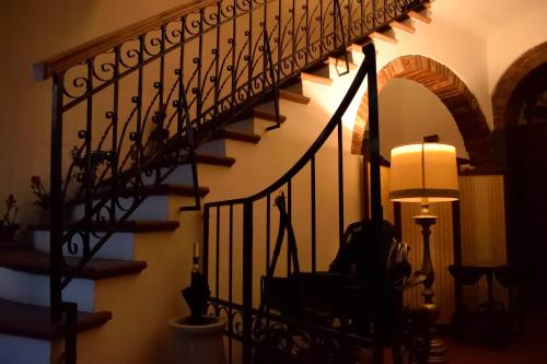 a spiral staircase in a living room with a lamp at Villa Irene in Magione