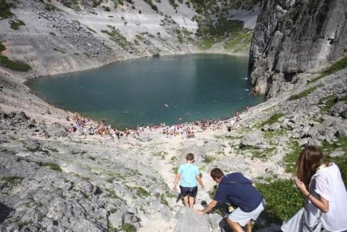 a group of people standing around a lake at Holiday house between the sea and lakes in Grubine