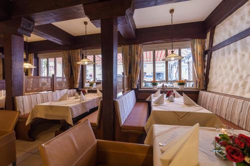 a restaurant with tables and chairs and windows at Zum Fässle in Hagnau