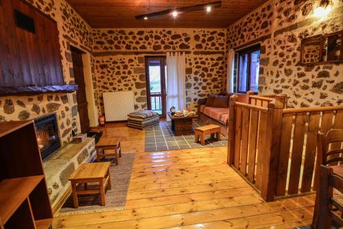 a living room with a couch and a fireplace at Εν Αρχή - En Arhi in Ano Trikala