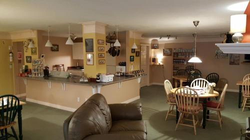 a living room with a couch and a table at The Inn at the Ninth Hole Bed & Breakfast in Salmon Arm