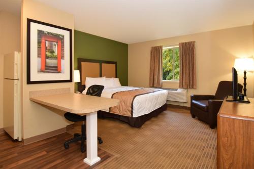 a hotel room with a bed and a desk at Extended Stay America Suites - Houston - Med Ctr - NRG Park - Kirby in Houston