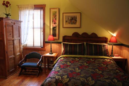 Rúm í herbergi á B&B Les Deux Pignons