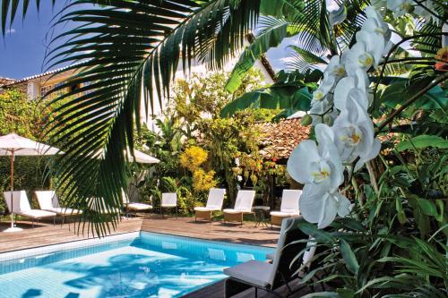 una piscina con un ramo de flores blancas en Pousada do Ouro, en Paraty