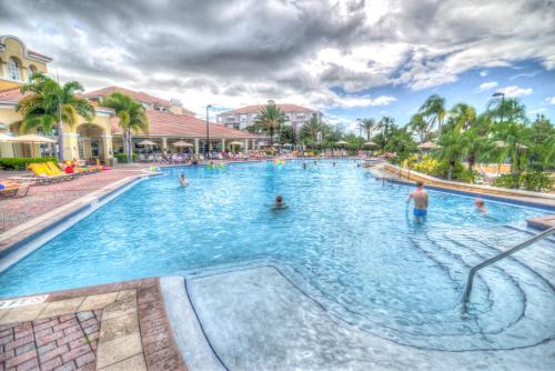 a swimming pool at a resort with people in it at Orlando Escape in Orlando