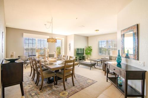 a dining room and living room with a table and chairs at Orlando Escape in Orlando
