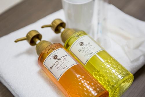 two bottles of wine sitting on top of a towel at HOTEL MYSTAYS Ueno Inaricho in Tokyo