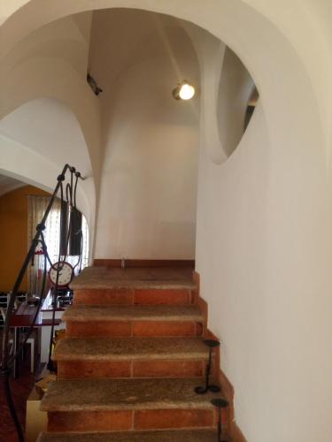 a set of stairs in a room with a white wall at B&B Villa Claudia in Lavena Ponte Tresa