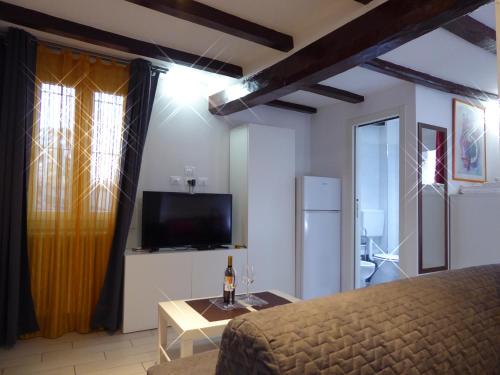 a bedroom with a bed and a flat screen tv at San Leonardo House Bologna in Bologna