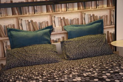 a bedroom with two pillows on a bed with books at la casa di asmei b & b Lucera in Lucera