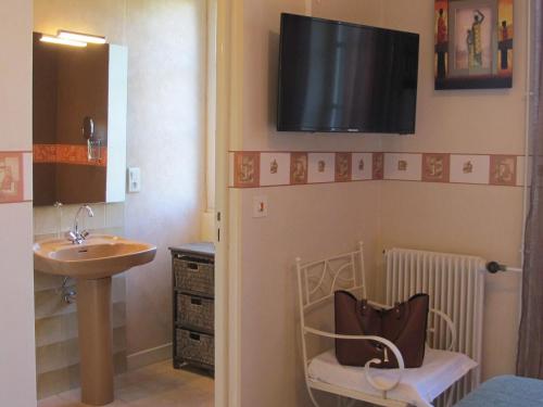 a small bathroom with a sink and a sink at Logis Deshors-Foujanet in Chamboulive