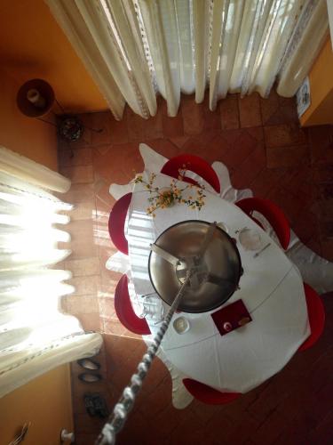 a room with a table and chairs with a rope at B&B Villa Claudia in Lavena Ponte Tresa