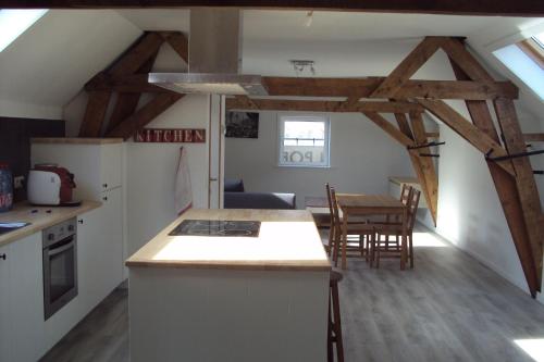 a kitchen and dining room with a table and chairs at Jules place in Wakken