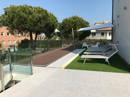 a group of chairs and a table on a lawn at Villa Liliana in Cervia